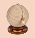 Animozen Isabella cat scratching ball with jute rope, wooden base, and feather toy. Natural beige.