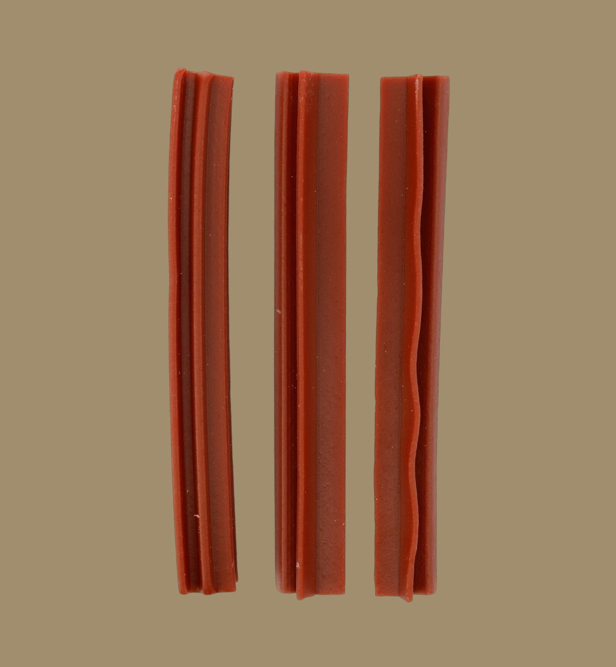 Animozen Veggie strawberry dog treats, made from sweet potato, in stick form with grooved texture.